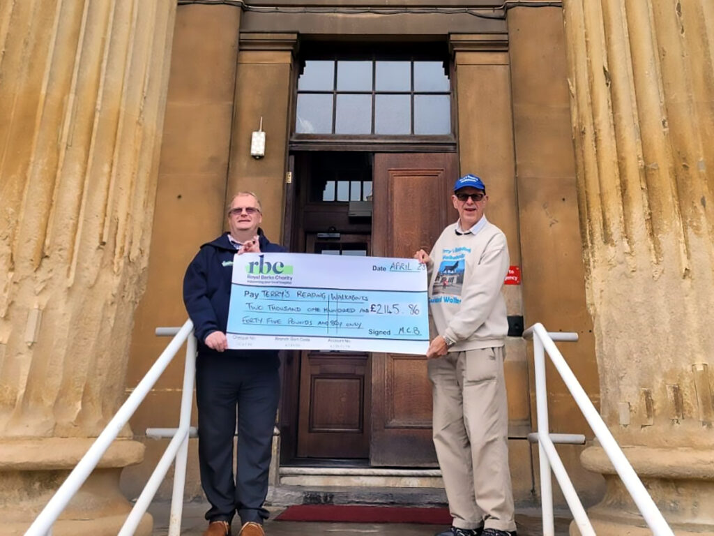 Terry Dixon (right) presenting a cheque to a charity in Reading